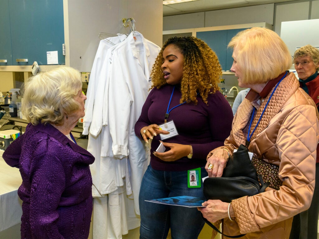 A post-doc student talks with donors during a special event