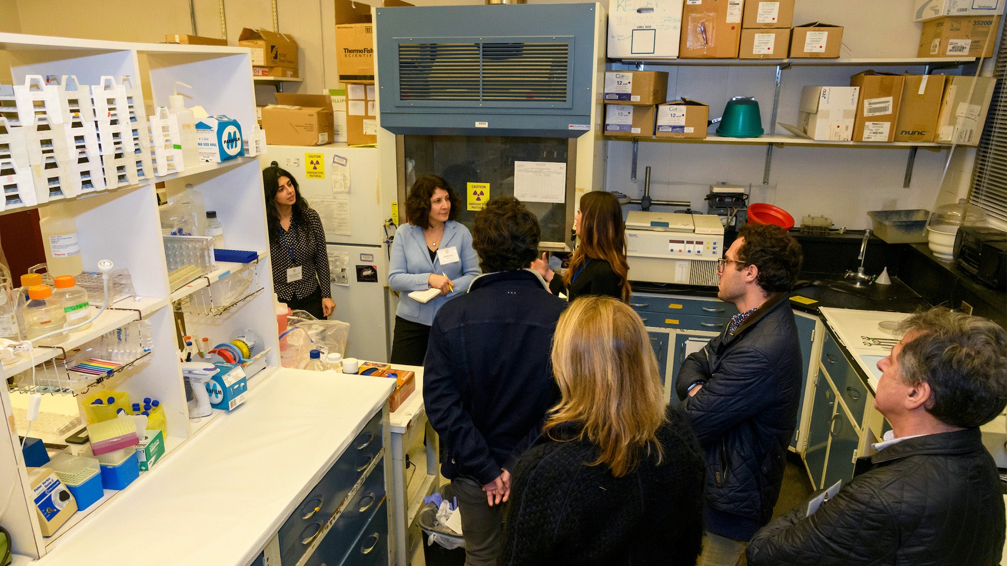 A group of people tour a lab